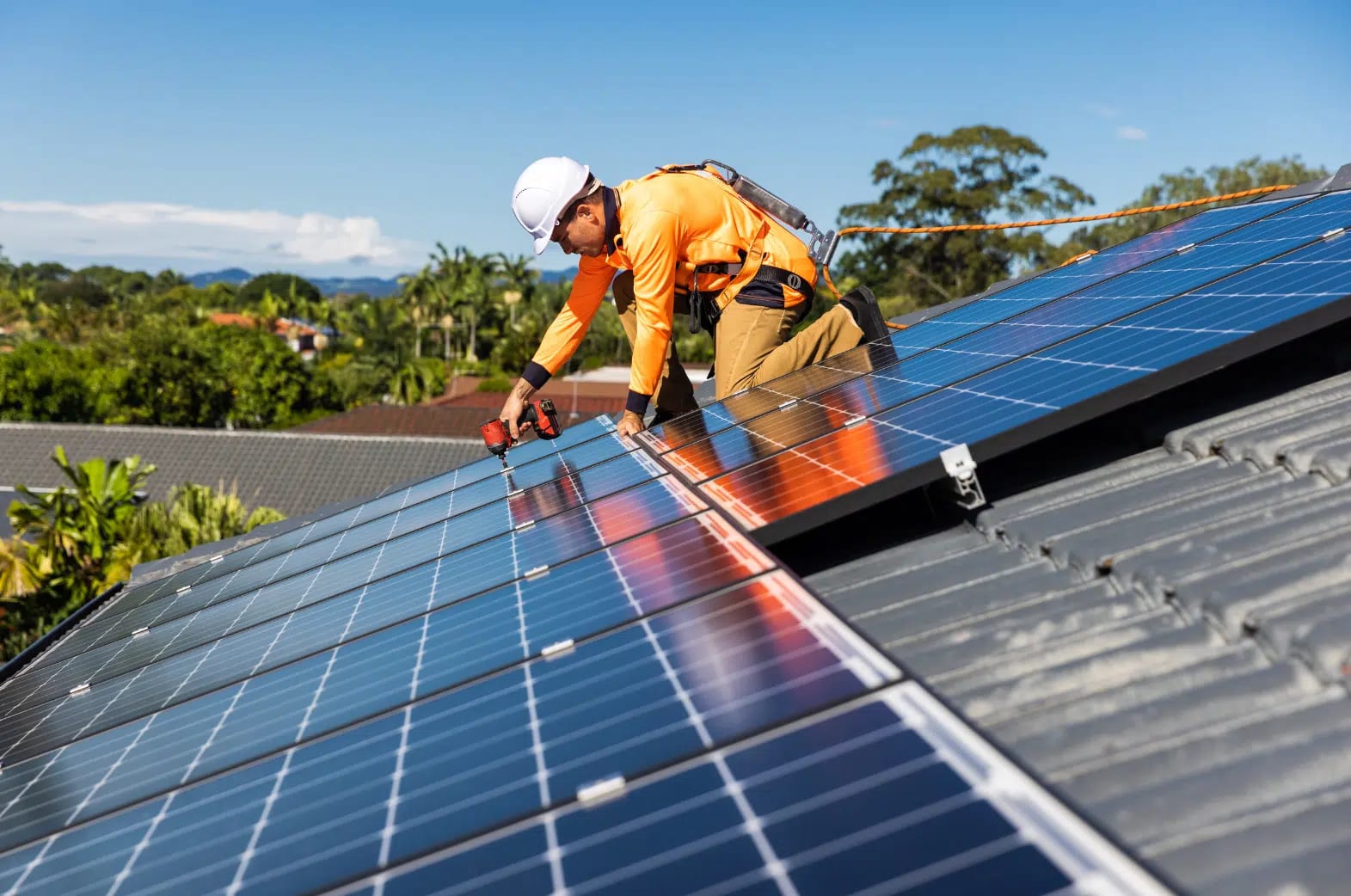 Array of solar panels on an industrial building, showcasing sustainable energy solutions provided by AES Group