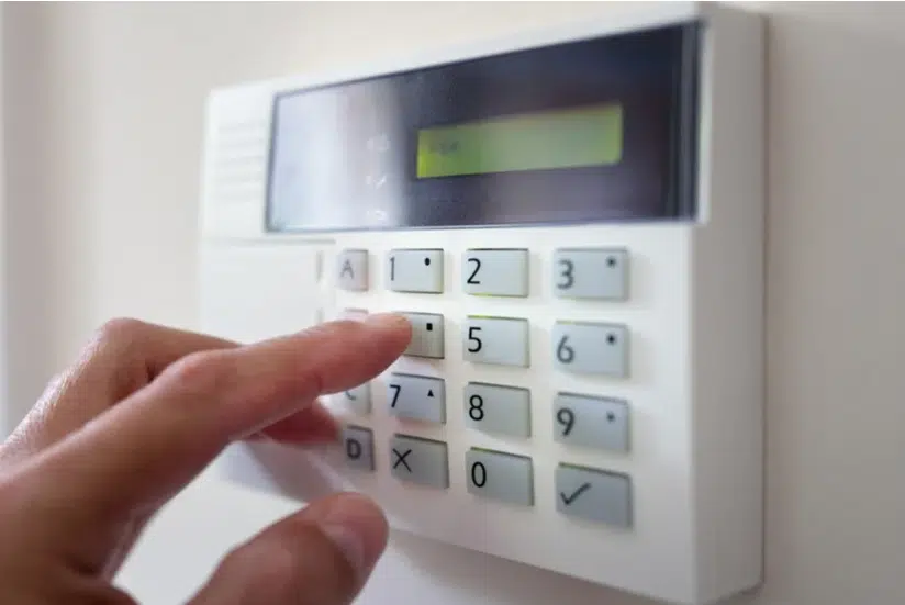 "AES Group security alarm keypad being activated for advanced commercial and industrial protection."